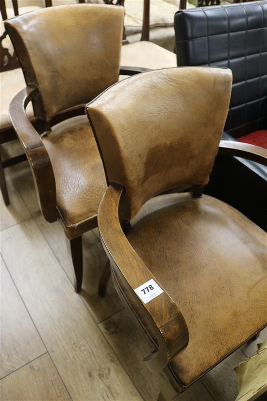 A pair of French leather elbow chairs